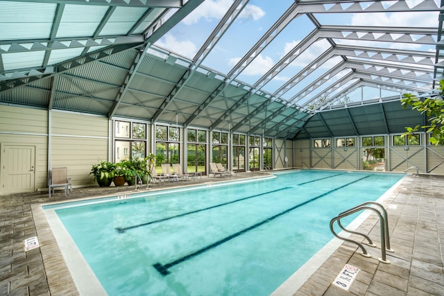 view of swimming pool featuring a lanai and a patio area