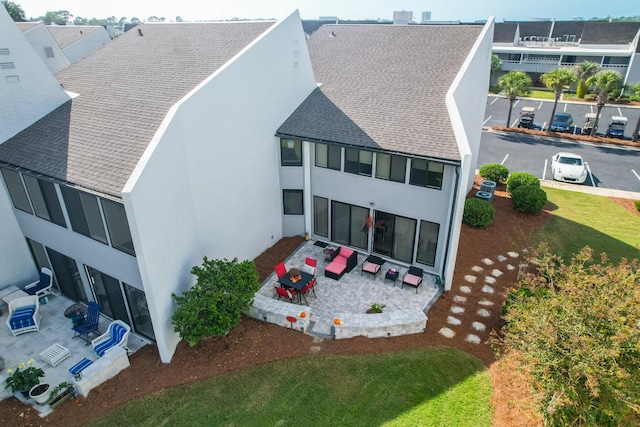 rear view of property featuring an outdoor hangout area