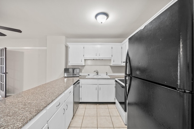 kitchen featuring sink, white cabinetry, stainless steel appliances, and light tile patterned floors