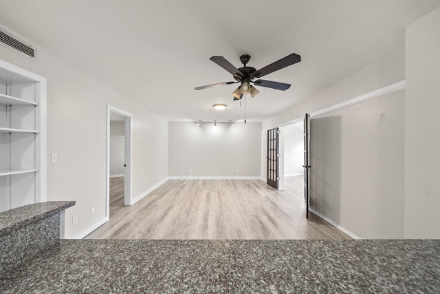 spare room featuring light wood-type flooring, rail lighting, and ceiling fan