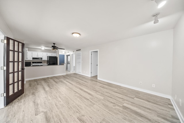 unfurnished living room with ceiling fan and light hardwood / wood-style flooring