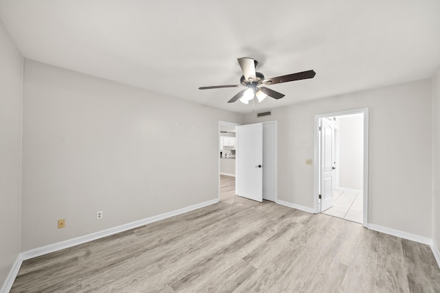 spare room featuring light wood-type flooring and ceiling fan