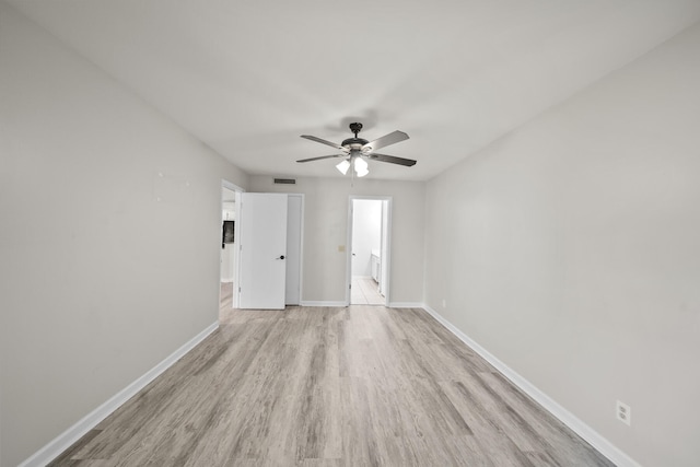 empty room featuring ceiling fan and light hardwood / wood-style floors