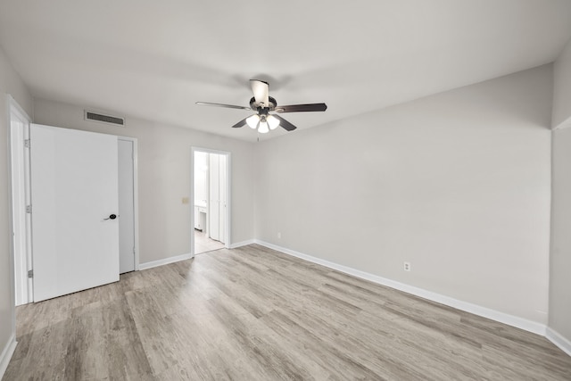 empty room with ceiling fan and light hardwood / wood-style floors