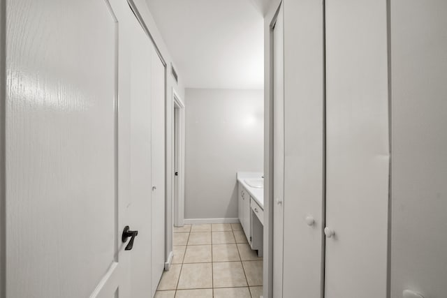 bathroom with tile patterned flooring and vanity