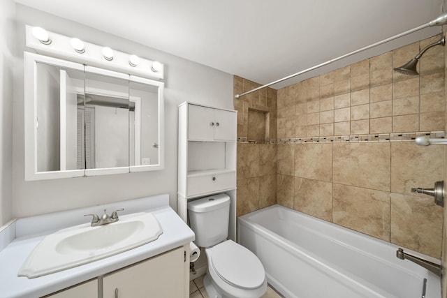 full bathroom featuring tile patterned flooring, vanity, toilet, and tiled shower / bath