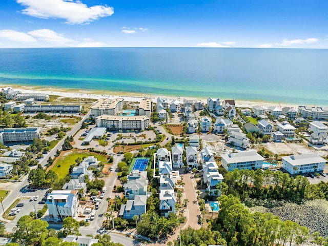 birds eye view of property with a water view and a view of the beach