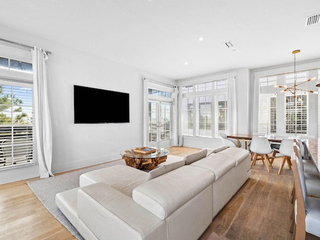 living room featuring hardwood / wood-style floors and a notable chandelier