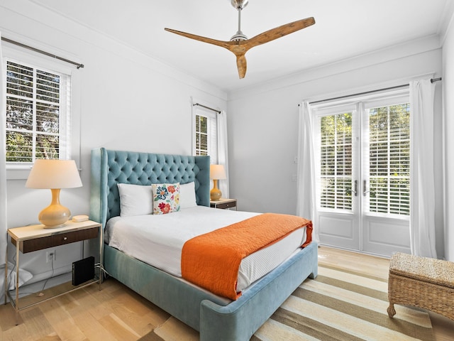 bedroom featuring light wood-type flooring, ceiling fan, and crown molding