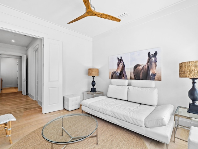 living room featuring hardwood / wood-style floors and ornamental molding