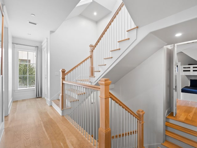 staircase with hardwood / wood-style floors