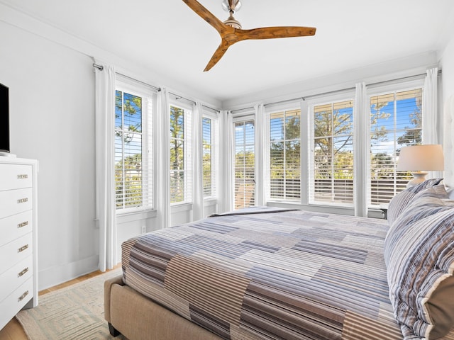 bedroom with ceiling fan and light hardwood / wood-style floors