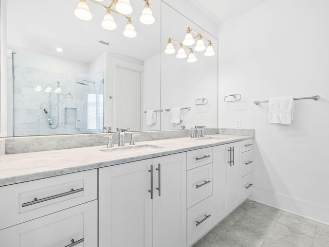 bathroom with vanity and a shower with shower door