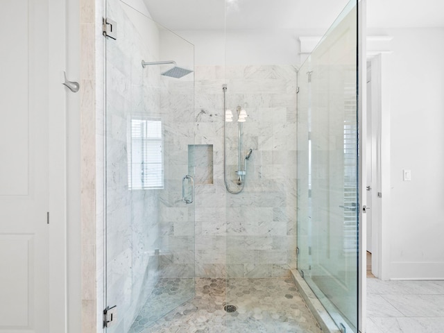 bathroom with a shower with door