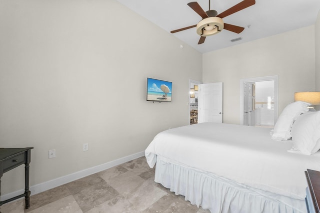 bedroom featuring ensuite bath, ceiling fan, and vaulted ceiling