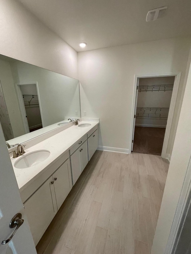 836 Coastal Breeze Dr, Freeport, FL 32439 - full bath featuring a spacious closet, wood finished floors, and double vanity