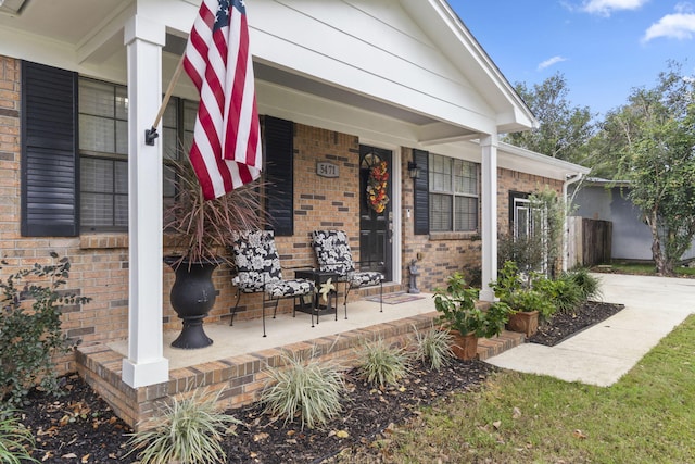 view of exterior entry featuring a porch