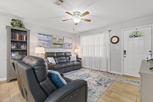 living room featuring light wood-type flooring and ceiling fan