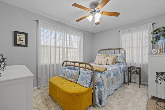 bedroom featuring light carpet and ceiling fan