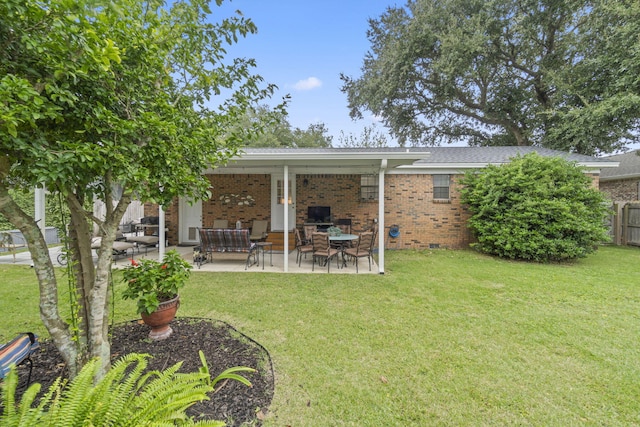 rear view of house with a patio area and a lawn