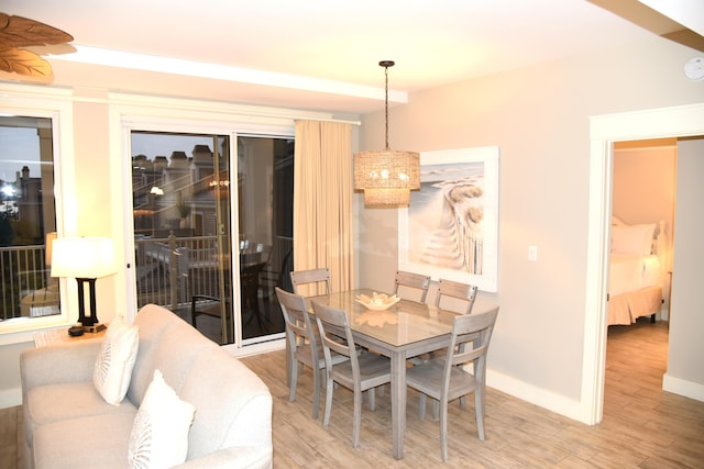 dining room with wood-type flooring and a notable chandelier