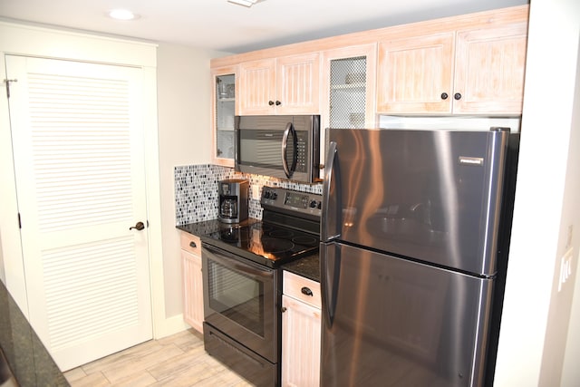 kitchen featuring appliances with stainless steel finishes, backsplash, light hardwood / wood-style flooring, and light brown cabinetry