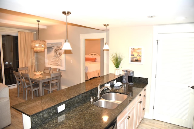 9200 Baytowne Wharf Blvd Unit 444/446, Miramar Beach, FL 32550 - kitchen with a sink, light wood finished floors, decorative light fixtures, and dark stone countertops
