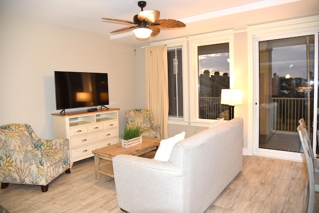 living room featuring light hardwood / wood-style floors and ceiling fan