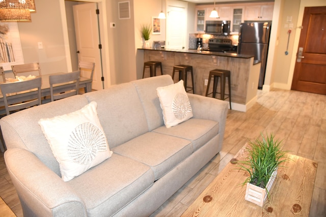 living room with light hardwood / wood-style flooring