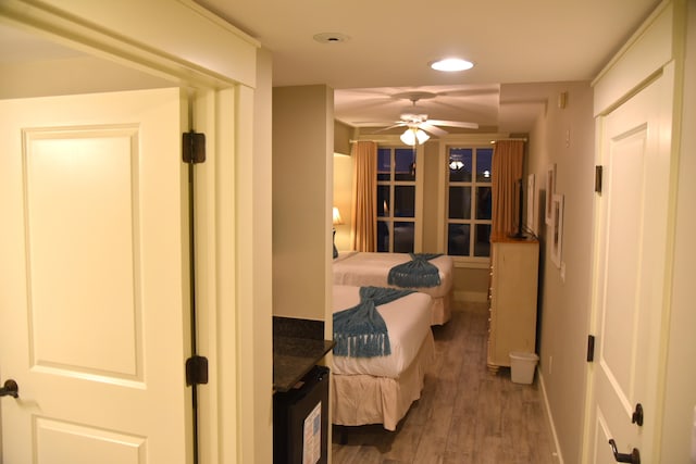 bedroom featuring ceiling fan and dark wood-type flooring