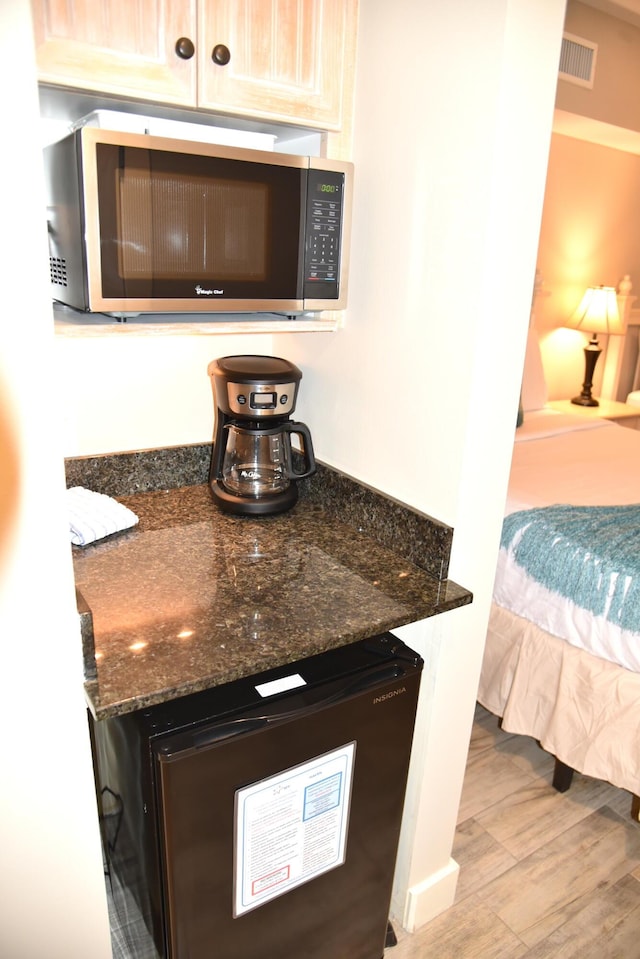 9200 Baytowne Wharf Blvd Unit 444/446, Miramar Beach, FL 32550 - bar with stainless steel microwave, wood finished floors, and freestanding refrigerator