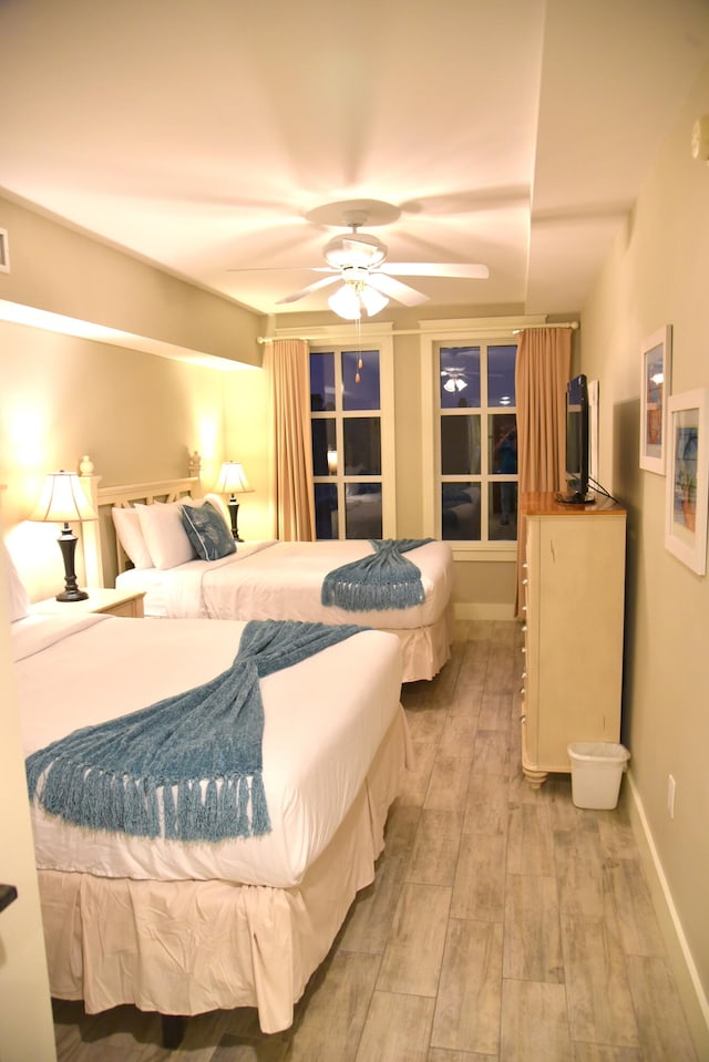 bedroom with ceiling fan and wood-type flooring