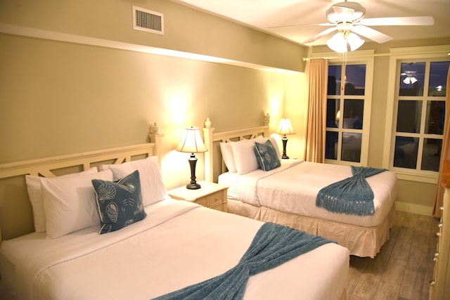 bedroom with ceiling fan and dark hardwood / wood-style flooring