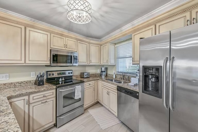 kitchen featuring sink, cream cabinetry, and appliances with stainless steel finishes