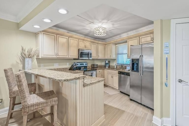 kitchen featuring a kitchen breakfast bar, light hardwood / wood-style flooring, light stone countertops, kitchen peninsula, and stainless steel appliances