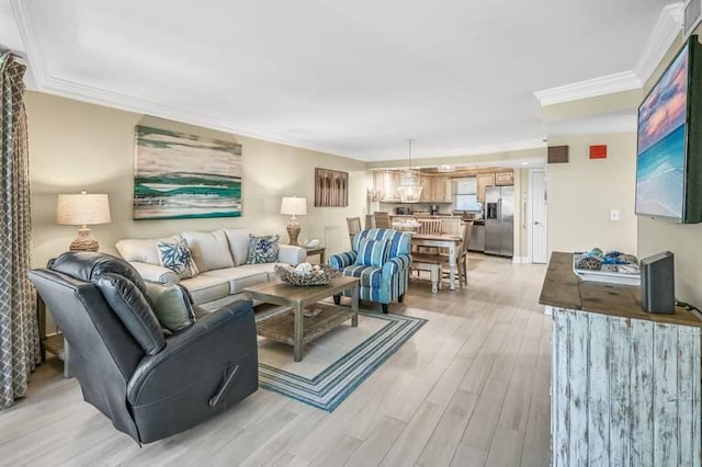 living room featuring crown molding and light hardwood / wood-style flooring