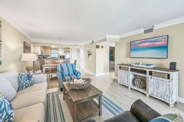 living room featuring light hardwood / wood-style floors and ornamental molding