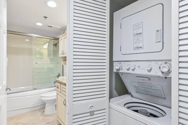 washroom with stacked washer / dryer