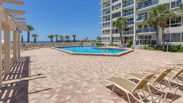 view of swimming pool featuring a pergola and a patio