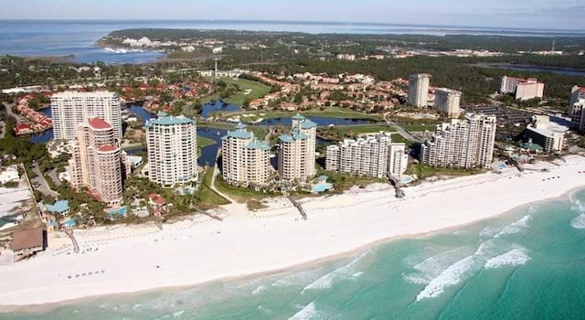 bird's eye view featuring a water view and a beach view