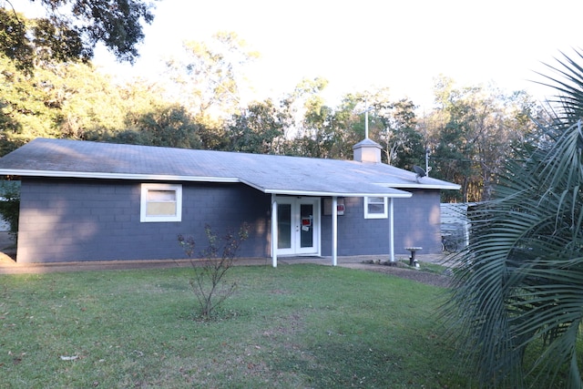 view of front of house with french doors and a front yard