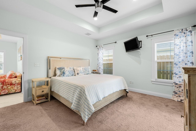 bedroom with ceiling fan, carpet floors, and multiple windows