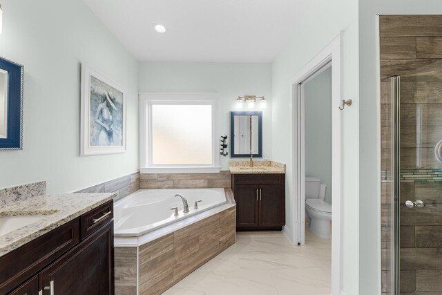 full bathroom with shower with separate bathtub, vanity, and toilet