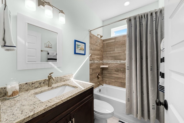 full bathroom featuring shower / bath combination with curtain, vanity, and toilet