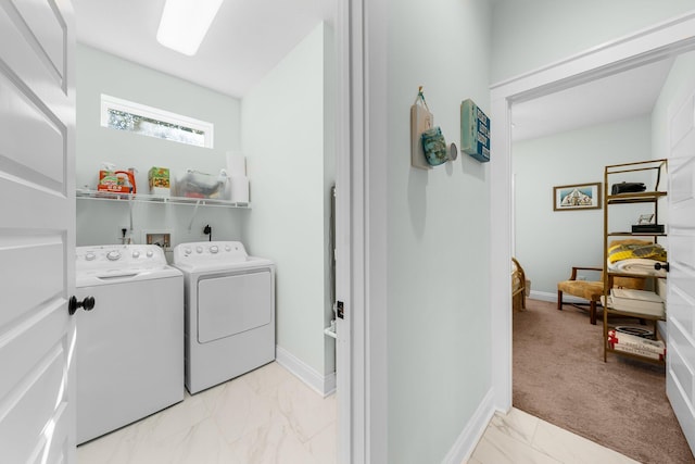 laundry area with washing machine and dryer and light colored carpet