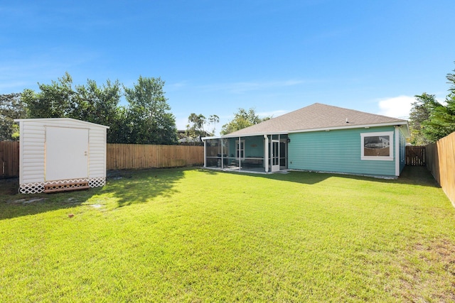 view of yard featuring a sunroom and a storage shed