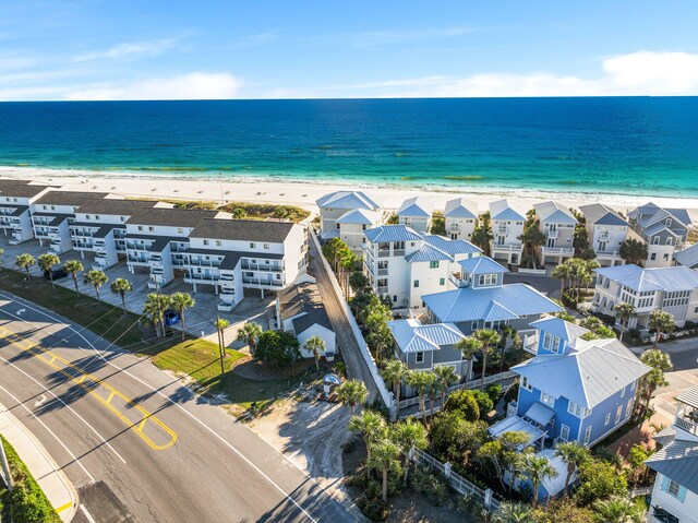 birds eye view of property with a view of the beach and a water view