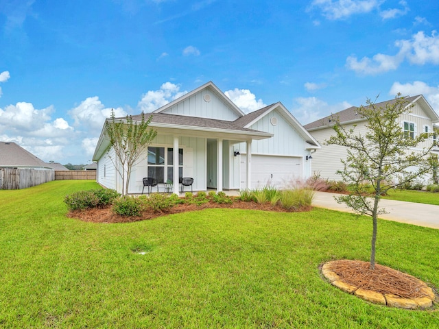 view of front of house featuring a porch, a garage, and a front yard