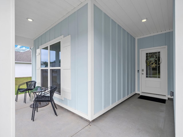 131 W Oak Trees Ln, Freeport, FL 32439 - view of exterior entry with covered porch and board and batten siding