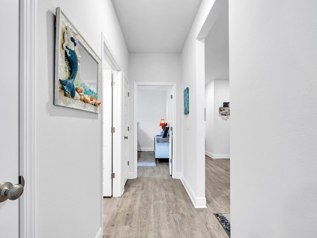 corridor with light wood-type flooring